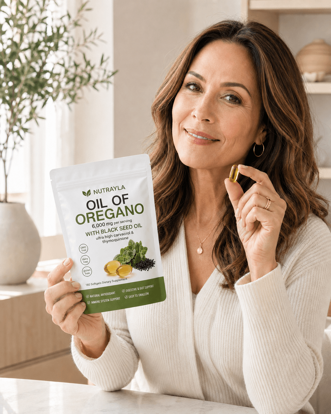 Woman holding a NUTRAYLA® Oil of Oregano pouch and one softgel